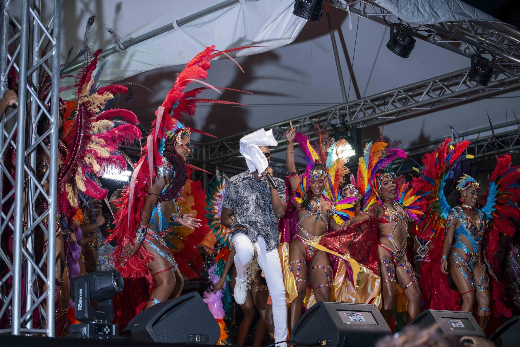 Feathered costumes fill the stage at the Take Off 2027 band launch